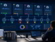 Procurement manager reviewing supplier reliability signals on a digital dashboard in a paper warehouse