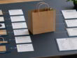 Kraft paper bag centered in a desk layout linking bag components to declarations, test reports, and a bill of materials.