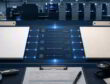 Two paper sample stacks flank a glowing comparison panel on a print quality bench in a pressroom.